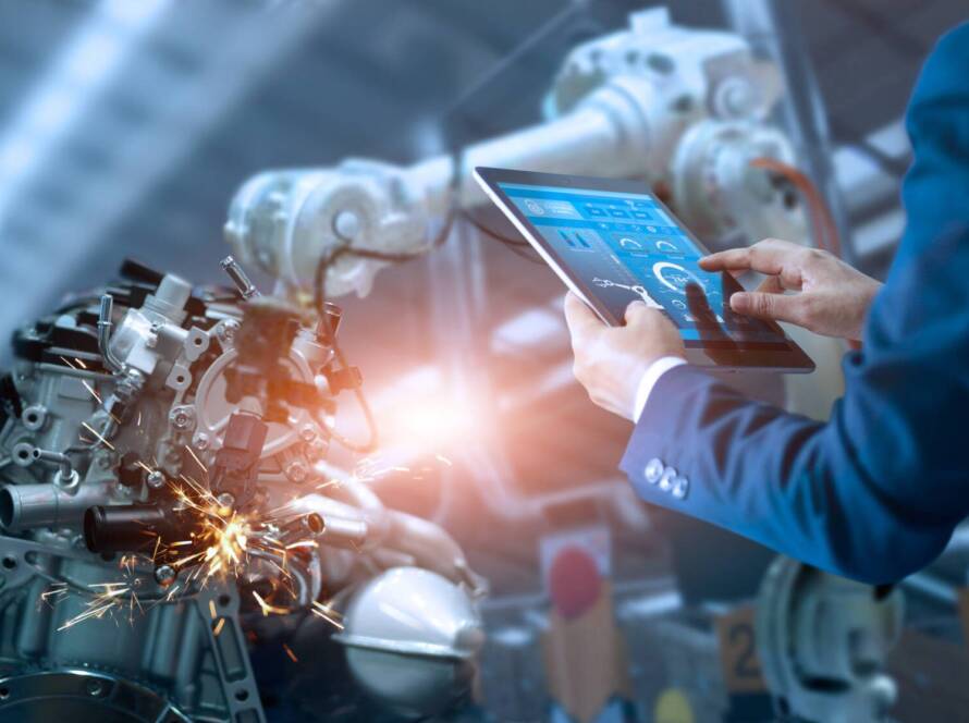 Manager engineer check and control automation robot arms machine in intelligent factory industrial on real time monitoring system software. Welding robotics and digital manufacturing operation.