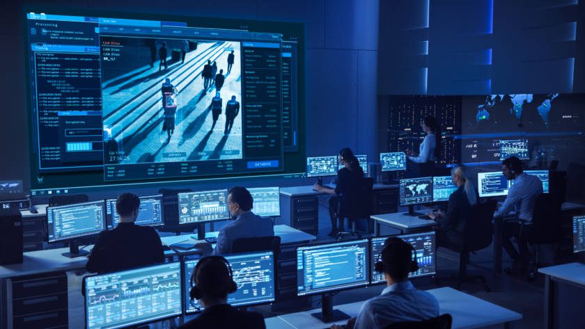 Team of Professional Cyber Security Data Science Engineers Work on Surveillance Tracking Shot of People Walking on City Streets