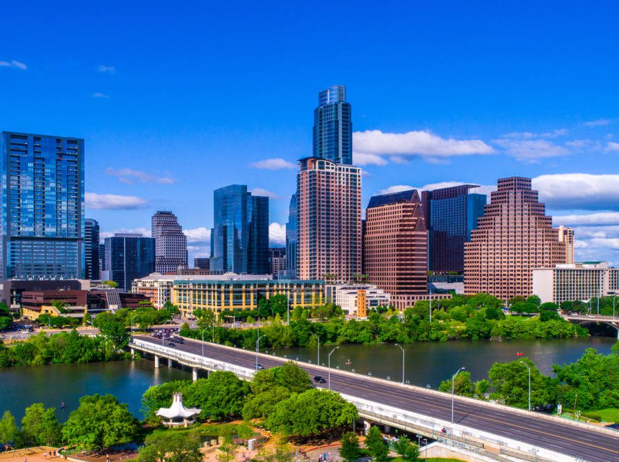 Austin Texas skyline during mid-day sunny summer perfect blue sky with entire city scape office buildings capital cities cityscape auditorium shores Panoramic