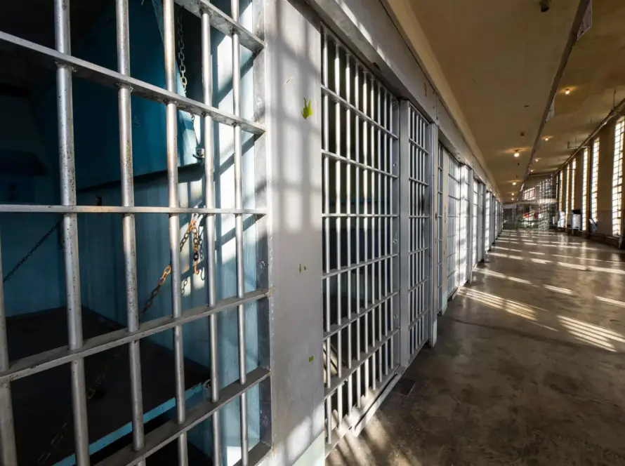 sun shining on the bars of a historic prison
