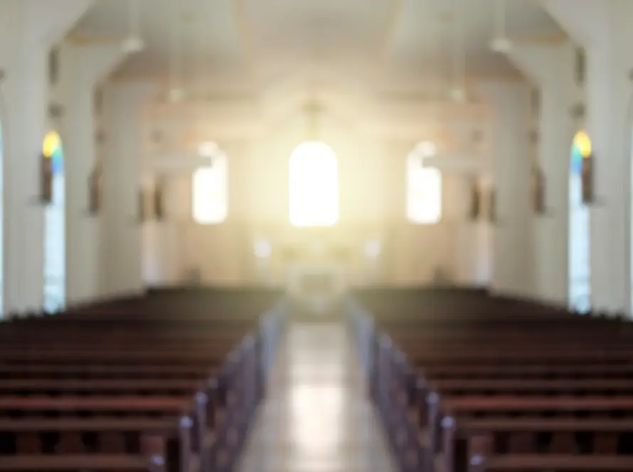 Blurred background of a surreal illuminated church aisle.