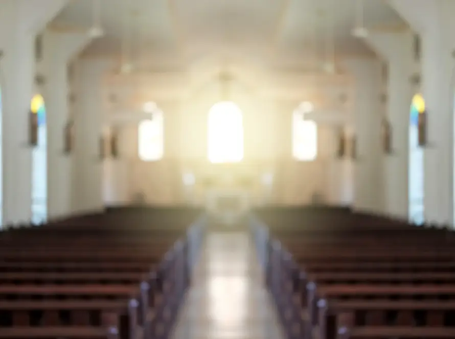 Blurred background of a surreal illuminated church aisle.